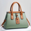 Elegant mint green crossbody handbag with brown lychee textured leather handles. - 28x14x20cm / Green