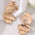 Macro view of golden irregular leaf earrings with refined brushed metal texture - EZ5325-E Abstract Layered Metal