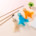 Three wooden cat wands with colorful feathers, woven balls and bells on pink background - Paper Rope Ball Feather