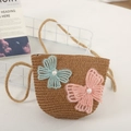 Detail of girls' brown straw shoulder bag with delicate lace butterfly and pearl accents - Khaki Bag