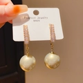 Close-up of elegant gold bow earrings with sparkling rhinestones and white pearls on card - 925 Sterling Silver Earring Post - Champagne Geometric Pearl