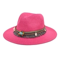 Detail of rose red straw hat featuring a bohemian ribbon with beads and turquoise stone - Rose Red