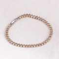Macro detail of marquise-cut champagne zircon stones on a silver tennis bracelet - Champagne Zircon - Platinum