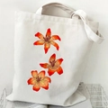 Off-white canvas tote bag featuring a vibrant orange lily floral illustration print - Orange Lilies (Off-white)