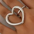 Polished silver stainless steel open heart ring shown on a finger for style - Silver (PB681)