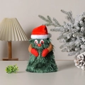Detail of plush Christmas tree toy with red Santa hat and gloves on warm wooden desk - Small Rotating Tree