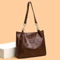 Large dark brown leather tote bag with chain strap shown on a geometric block - EU 32 / Dark Brown