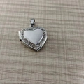Silver heart locket pendant with sparkling diamond border on light wooden background - Rhinestone Style Pendant Only / Silver