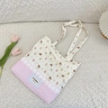 Close-up of quilted tote bag with cute bear print, lace trim, and pink heart stitching - Puppy Bear