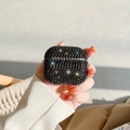 Macro detail of hand holding a luxury black rhinestone studded wireless earphone case - Black Rhinestone