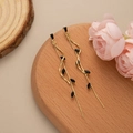 Elegant gold long leaf tassel earrings with black marquise drops on wooden display - Gold - Black Zirconia