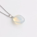 Detail showing white opal gemstone pendant on silver chain for elegant necklace - Opal