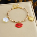 Bohemian woven rope bracelet featuring red lip and golden sun charms on a gift box - Red Lips Sun Charm Style (B1837)