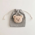 Macro view of grey corduroy drawstring bag with a 3D plush bear decorative detail - Grey (Milk Tea Bear)