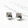 Detail shot of silver crown charms and facial reliefs for DIY charm bracelet beads - Crown
