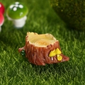 Miniature resin tree stump figurine with yellow mushrooms and green leaf on moss - US 5