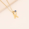 Collier doré avec pendentif lettre K et breloque œil bleu sur une fine chaîne dorée - Lettre K