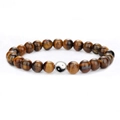 Tiger eye beaded bracelet with silver Yin Yang charm bead on a clean white background - Tiger Eye Stone Bracelet