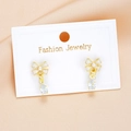 Delicate gold bow earrings with white enamel and teardrop zircon on jewelry card - Bow Teardrop Style (6064001)
