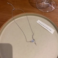 Silver bowknot planet necklace with blue star stone and zircons on a ceramic plate - Planet and Stars Element / Silver/Blue Purple Star Stone