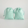 Pair of mint green faux suede drawstring jewelry pouches with soft matte texture - Light Green