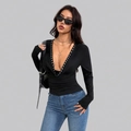 Detail of black slim-fit long sleeve top featuring a deep V-neck with silver rivets - S / Black
