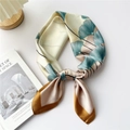 Elegant silk scarf featuring green ginkgo leaves on cream base with golden edges - Lotus Pink Ginkgo Leaf