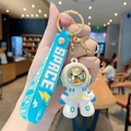 Cool cartoon astronaut keychain with blue silicone wrist strap and golden space helmet - Dazzling Astronaut-Green