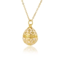 Detailed close-up of golden egg pendant with white enamel and hollow floral patterns - White