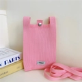 Detailed view of pink knitted phone bag featuring a metal buckle and woven strap - Pink