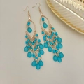 Vintage bohemian tassel earrings featuring layered lake blue beads and gold chains - Peacock Blue