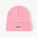 Pink knitted beanie featuring IT IS WHAT IT IS embroidery for winter warmth and style - One Size / Pink