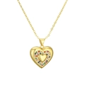Macro detail of gold heart pendant featuring vibrant rainbow cubic zirconia settings - Rainbow Pave Double Heart