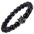 Close-up of wolf head bead with green eyes on lava rock and black agate bracelet - Lava Stone + Matte Stone