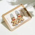 Detail van geborduurde peperkoekman-haarspeldjes met zilveren glitters voor Kerstmis - Kerst Lebkuchenmann Paar