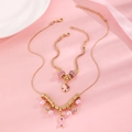 Detailed view of pink ribbon awareness jewelry set with pearls and rhinestones - Gold Pink Ribbon Pearl Combination Set