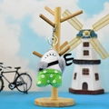 Funny shark plush keychain holding a pitchfork on a wooden stand display - Shark with Pants & Fork (Lobster Clasp) / 10cm