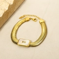 Detail of 18K gold plated snake chain bracelet featuring white shell and zircon - White