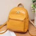 Mini yellow crocodile pattern backpack with gold bow detail and adjustable straps - Earthy Yellow