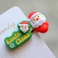 Macro shot of 3D Santa Claus hair clip with red hat on white jewelry card detail - Style 22 Christmas Hair Clip