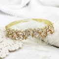 Macro shot of 18K gold plated bangle with micro-paved cubic zirconia on white lace - Style 4 12mm Wide