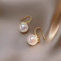 Close-up of golden earrings with iridescent pearls on a soft silk fabric background - Hook-8mm