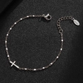 Detail view of silver stainless steel bracelet featuring cross pendant and white beads - Silver-White