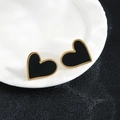 Macro detail of black heart studs with gold edges on white ceramic, elegant fashion jewelry - 106-Gold Black Shell