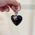 Minimalist black resin heart keychain with silver charms held against a plain backdrop - Large Heart Pendant / Black