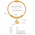 Detail of gold titanium steel bangle with heart charm and size specifications - Gold (Z257)