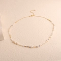 Detailed macro view of baroque freshwater pearl necklace with golden lobster clasp and beads - Seed Pearl Baroque Floral Blue Crystal