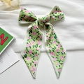 Pale green floral satin hair ribbon tied in a bow with delicate pink flower patterns - Green Floral Bliss