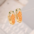 Detailed close-up of golden snake hoop earrings with orange enamel and green zircon eyes - Orange