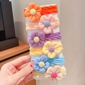 Close-up of 6 colorful floral elastic hair bands on a display card for little girls - A Flower Multicolor